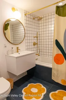 a bathroom with a sink mirror vanity and toilet
