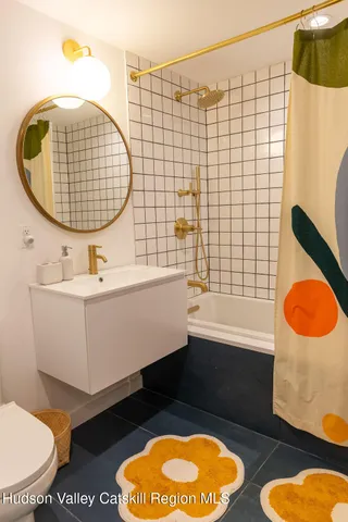a bathroom with a sink mirror vanity and toilet