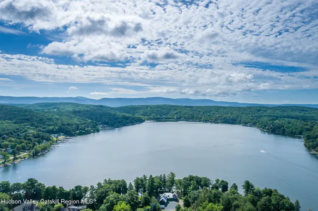 a view of a lake in middle of a field