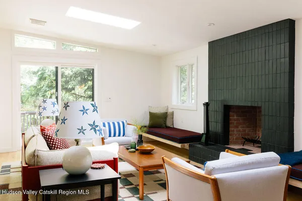 a living room with furniture fireplace and a table