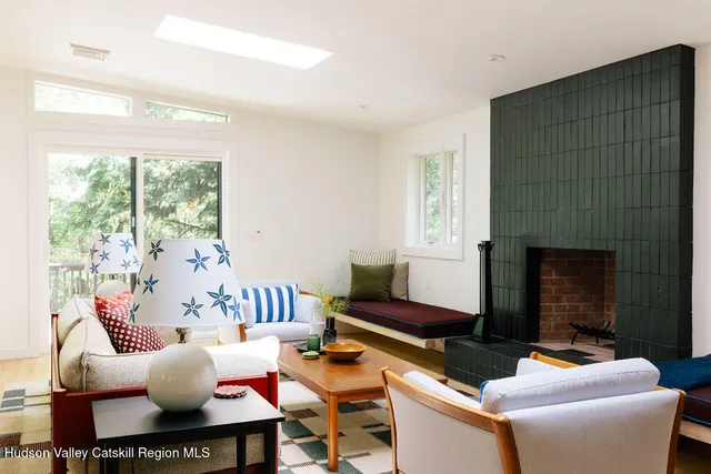 a living room with furniture fireplace and a table