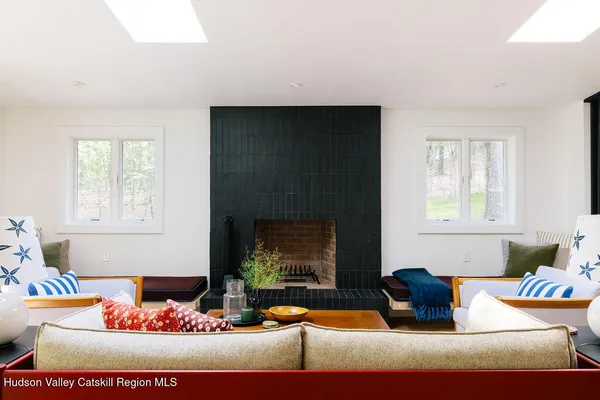 a living room with furniture fireplace and window
