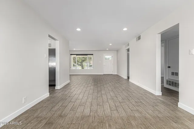 wooden floor in an empty room with a window