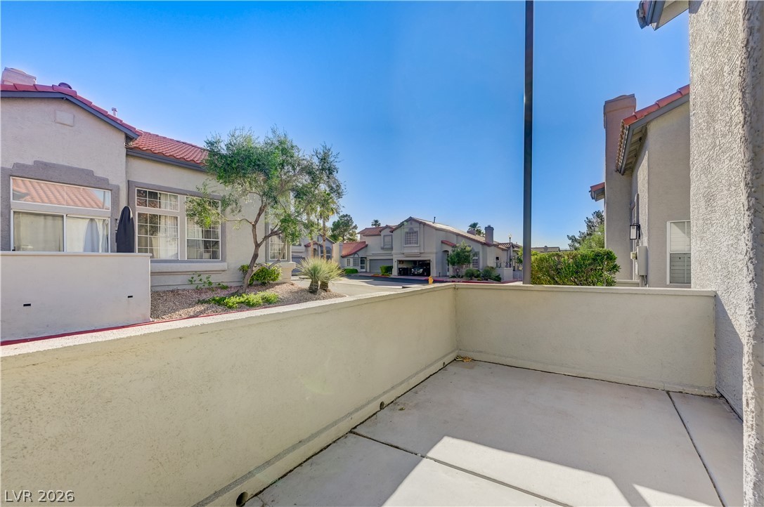 2232 Ramsgate Drive Henderson, NV 89074 - Photo 8 of 19 A private concrete balcony looks out over the surrounding neighborhood under clear blue skies.