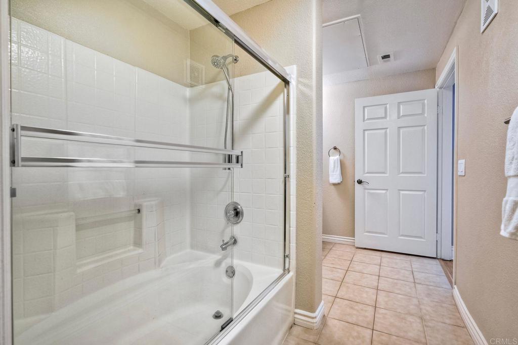 9263 Regents Road La Jolla, CA 92037 - Photo 17 of 37 a bathroom with a bathtub and a shower