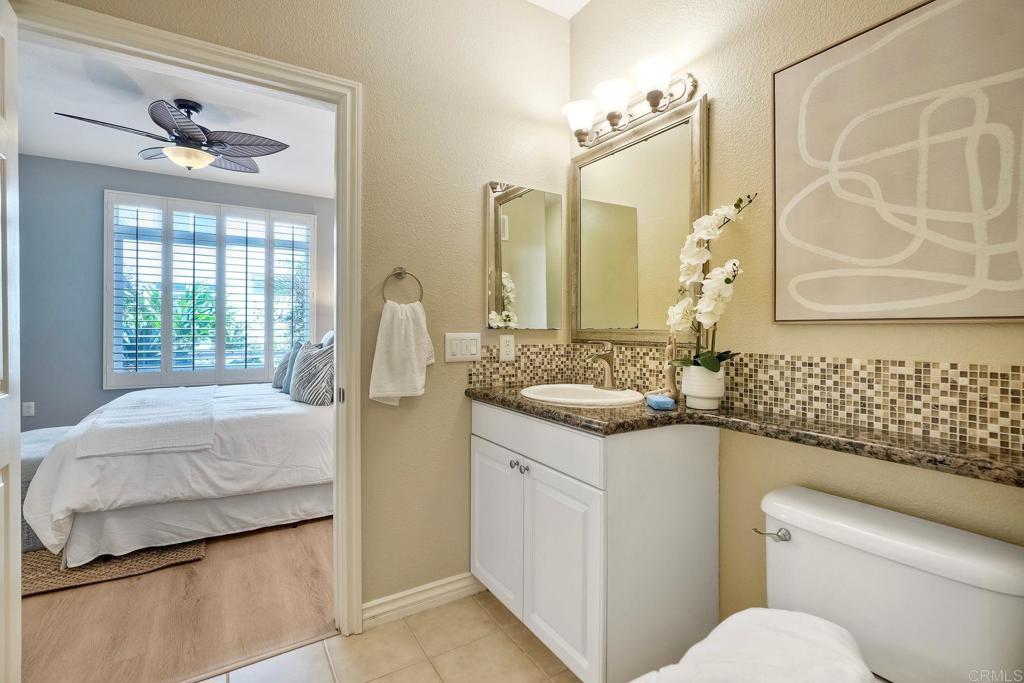 9263 Regents Road La Jolla, CA 92037 - Photo 23 of 37 a bathroom with a granite countertop sink and a mirror