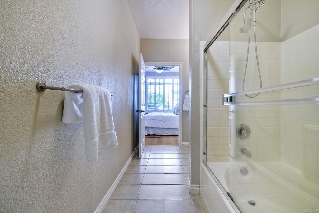 9263 Regents Road La Jolla, CA 92037 - Photo 24 of 37 a bathroom with a bathtub and a shower