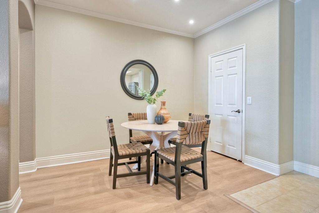 9263 Regents Road La Jolla, CA 92037 - Photo 3 of 37 a dining room with furniture and a mirror