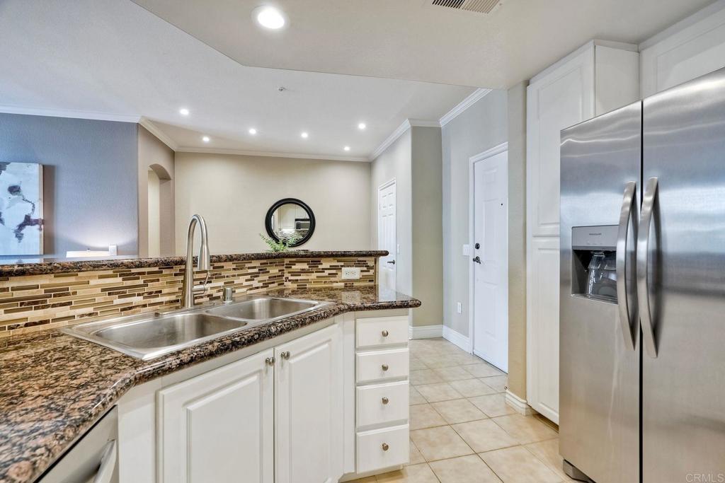 9263 Regents Road La Jolla, CA 92037 - Photo 10 of 37 a kitchen with granite countertop a sink and stainless steel appliances