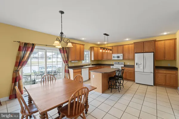 a dining room filled a chandelier a glass table and chairs