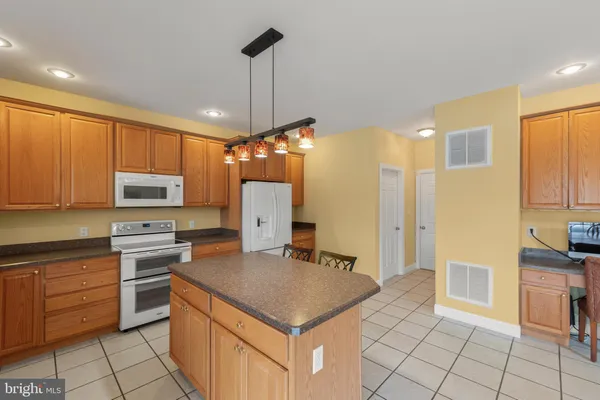 a kitchen with a stove a sink and a refrigerator