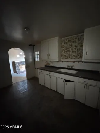 a kitchen with stainless steel appliances a sink stove and cabinets