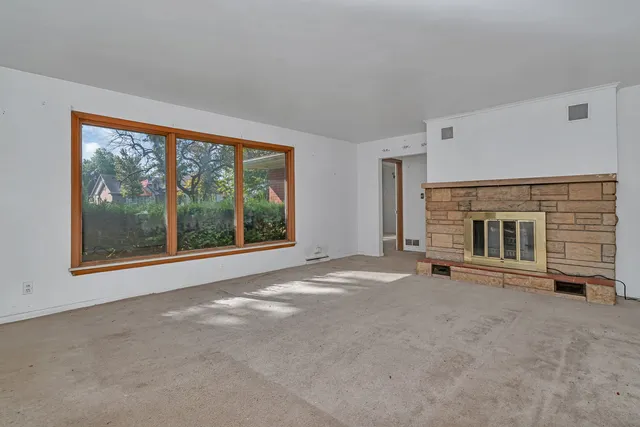 a view of empty room with a fireplace