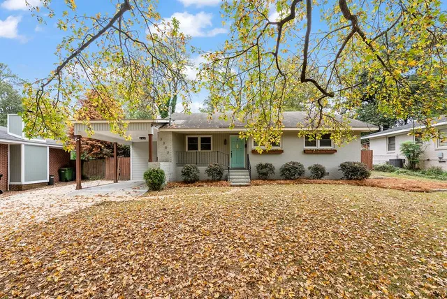 front view of a house with a chairs and a table