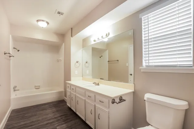 a bathroom with a double vanity sink and a mirror