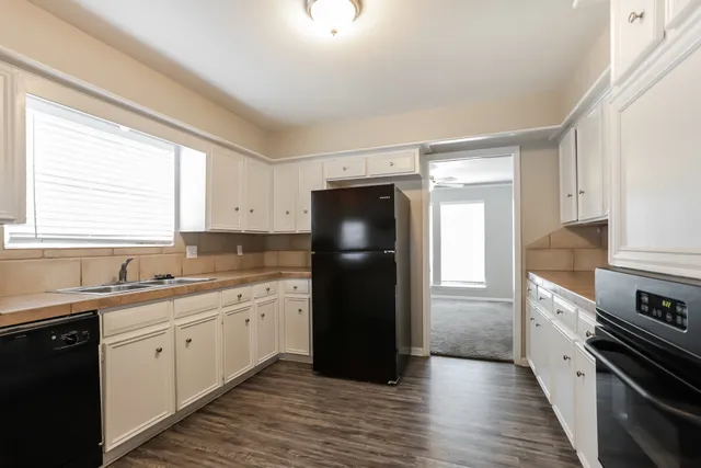 a kitchen with a sink a refrigerator and window