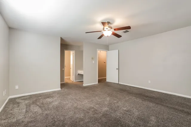 a view of an empty room with a fan