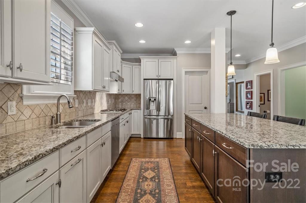 771 Harvest Pointe Drive Fort Mill, SC 29708 - Photo 16 of 48 a kitchen with stainless steel appliances granite countertop a sink stove and refrigerator