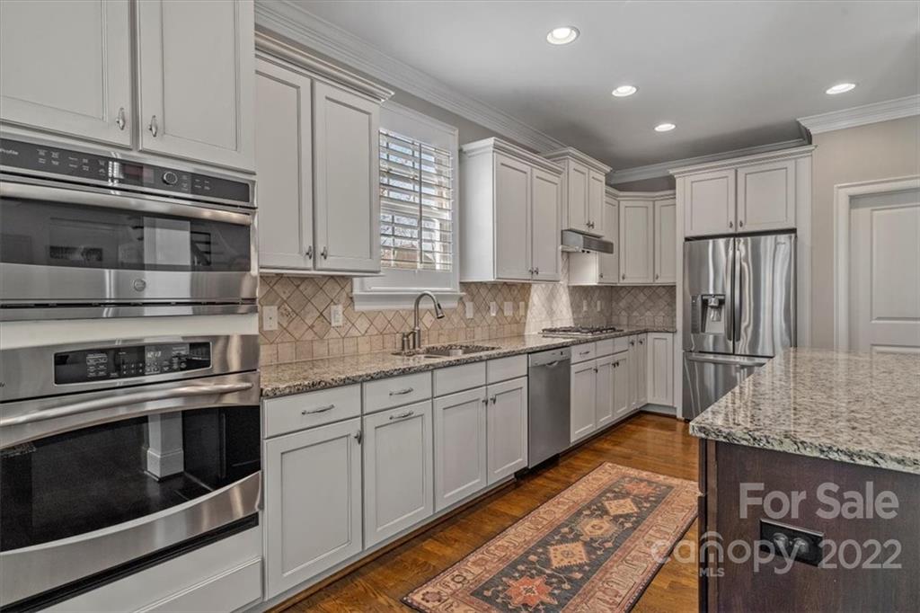 771 Harvest Pointe Drive Fort Mill, SC 29708 - Photo 17 of 48 a kitchen with stainless steel appliances granite countertop a stove a sink and a refrigerator