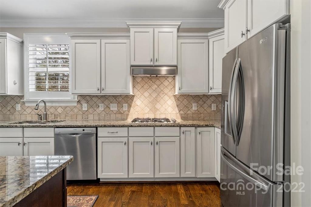 771 Harvest Pointe Drive Fort Mill, SC 29708 - Photo 18 of 48 a kitchen with granite countertop a refrigerator sink and cabinets