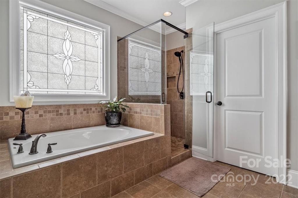 771 Harvest Pointe Drive Fort Mill, SC 29708 - Photo 34 of 48 a bathroom with a tub a sink and a window