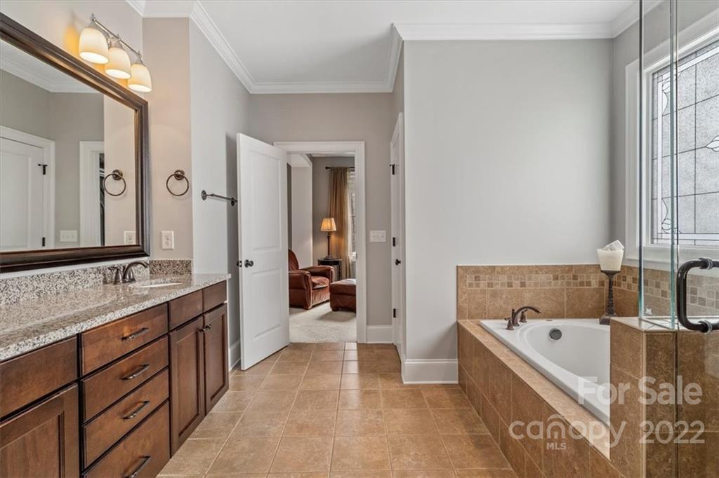 771 Harvest Pointe Drive Fort Mill, SC 29708 - Photo 35 of 48 a bathroom with a bathtub and a double vanity sink mirror