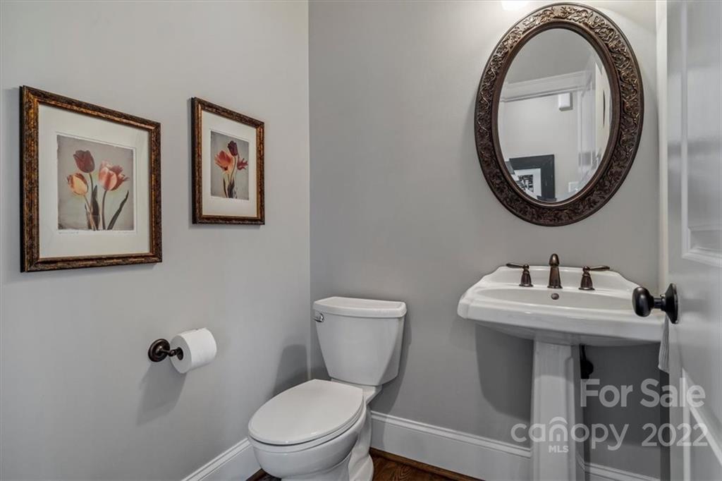 771 Harvest Pointe Drive Fort Mill, SC 29708 - Photo 7 of 48 a bathroom with a toilet a sink and a mirror