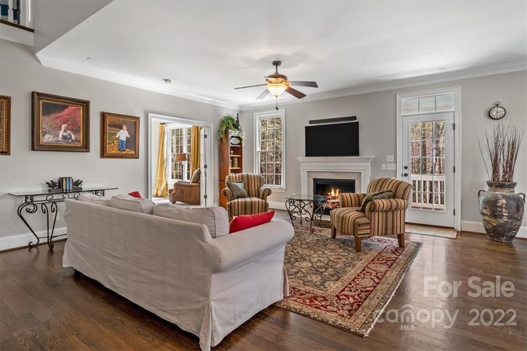 771 Harvest Pointe Drive Fort Mill, SC 29708 - Photo 8 of 48 a living room with furniture a flat screen tv and a fireplace