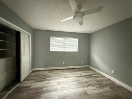a view of room with window and ceiling fan