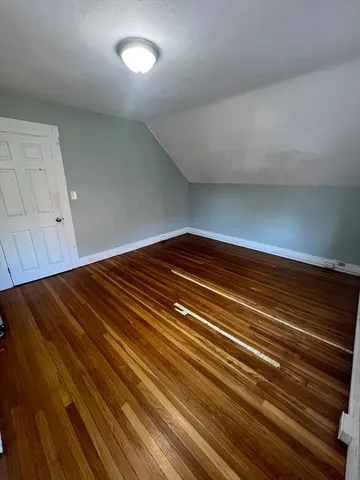 a view of room with wooden floor
