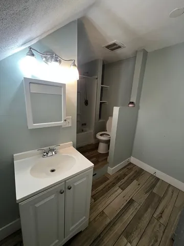 a bathroom with a sink toilet and mirror