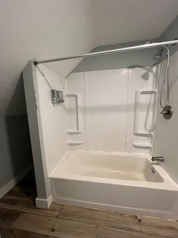 a bathroom with a shower and a tub