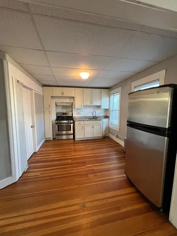 a room with wooden floor and furniture