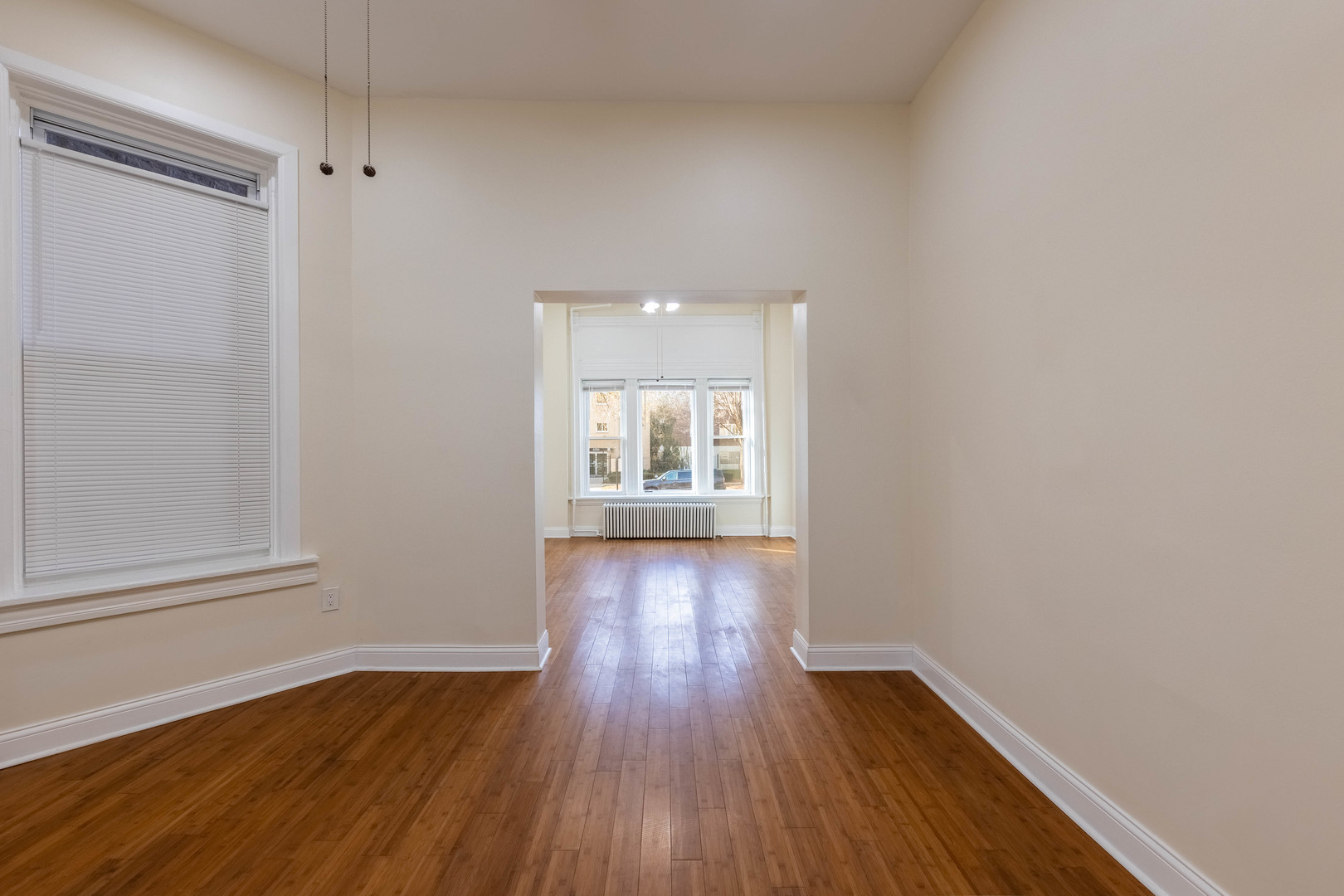 4549 South Wabash Avenue, Unit 1 Chicago, IL 60653 - Photo 12 of 44 a view of an empty room with wooden floor and a window