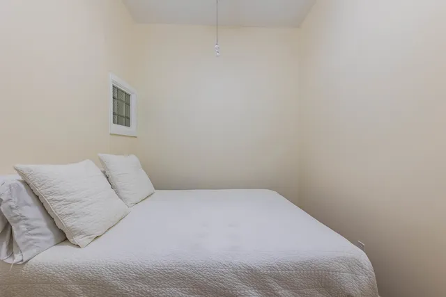 a bedroom with a bed and a night stand