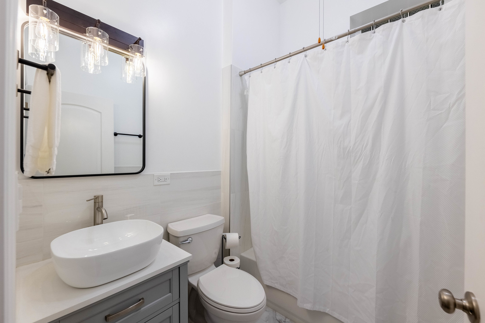 4549 South Wabash Avenue, Unit 1 Chicago, IL 60653 - Photo 19 of 44 a bathroom with a toilet a sink and a mirror