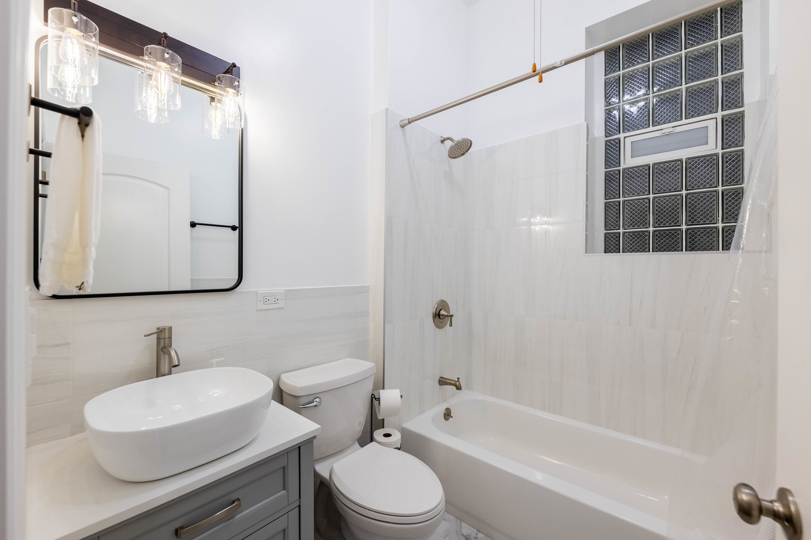 4549 South Wabash Avenue, Unit 1 Chicago, IL 60653 - Photo 20 of 44 a bathroom with a sink toilet a mirror and shower