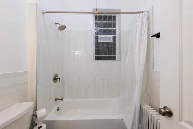 a bathroom with a bathtub and shower