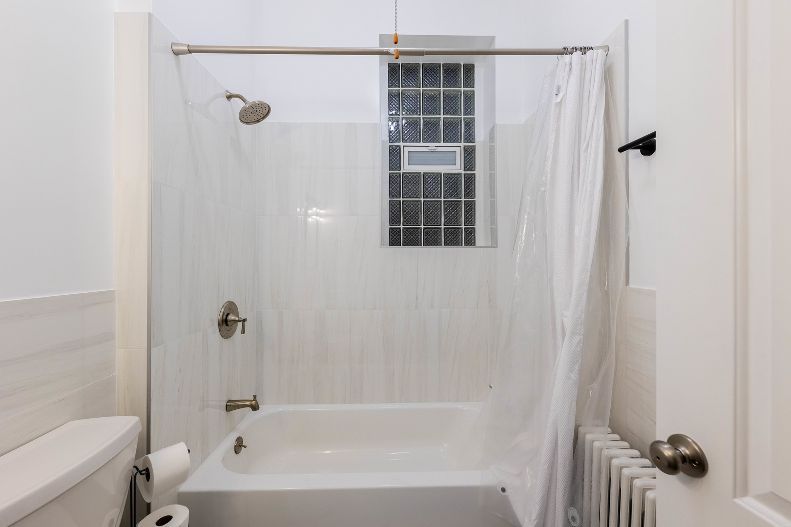 4549 South Wabash Avenue, Unit 1 Chicago, IL 60653 - Photo 21 of 44 a bathroom with a bathtub and shower