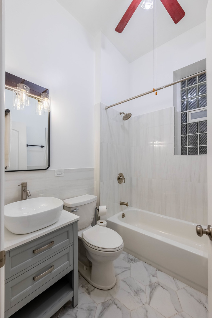 4549 South Wabash Avenue, Unit 1 Chicago, IL 60653 - Photo 22 of 44 a bathroom with a sink a toilet and shower