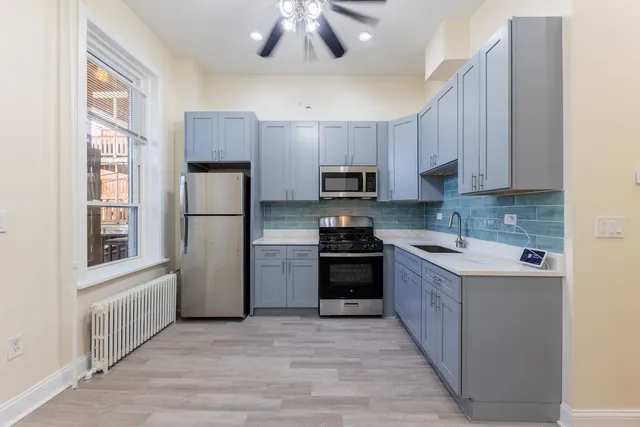a kitchen with a refrigerator a stove top oven a sink and dishwasher