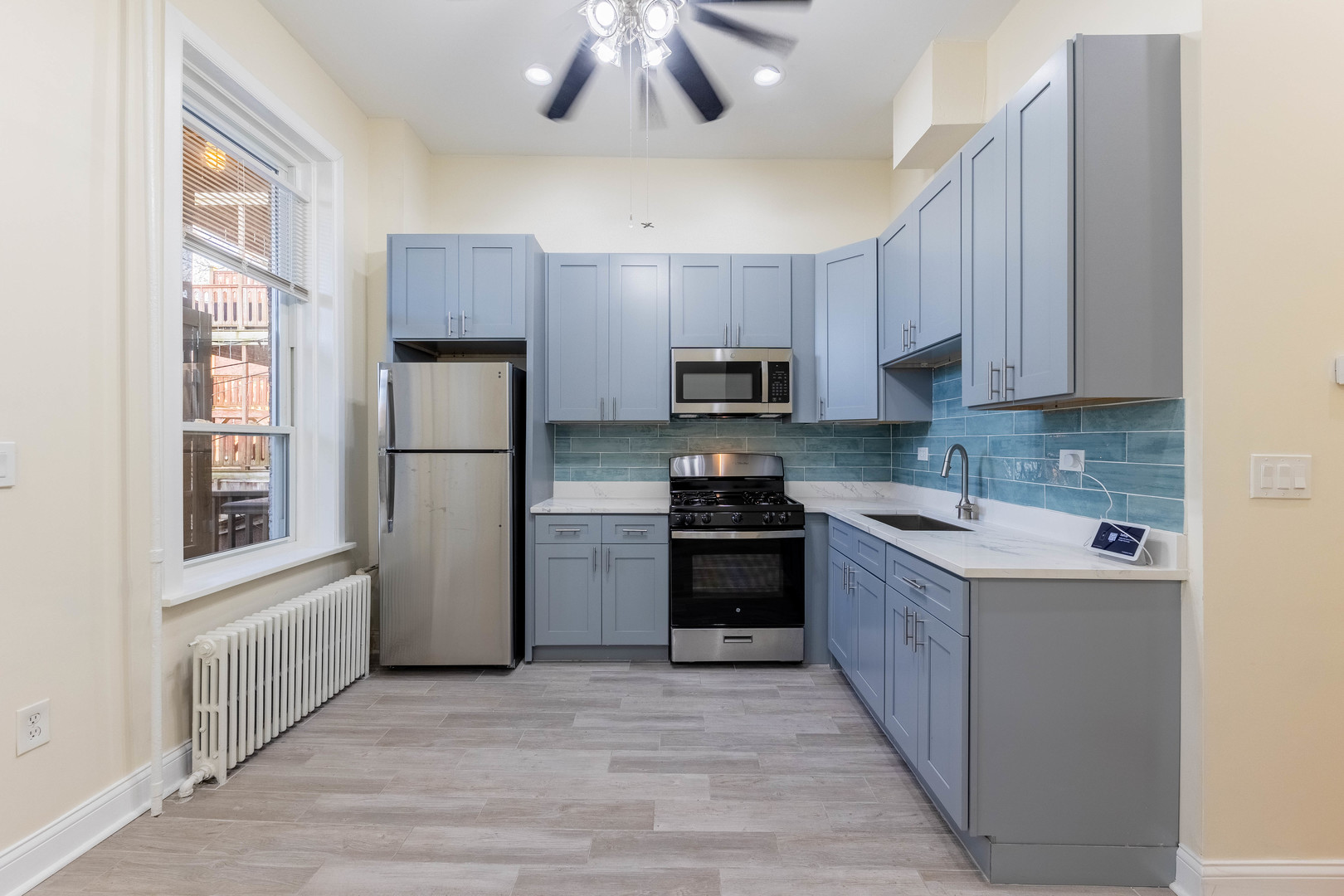4549 South Wabash Avenue, Unit 1 Chicago, IL 60653 - Photo 27 of 44 a kitchen with a refrigerator a stove top oven a sink and dishwasher