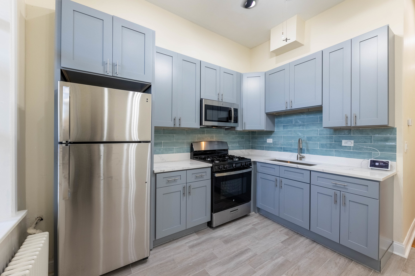 4549 South Wabash Avenue, Unit 1 Chicago, IL 60653 - Photo 28 of 44 a kitchen with cabinets stainless steel appliances and a sink