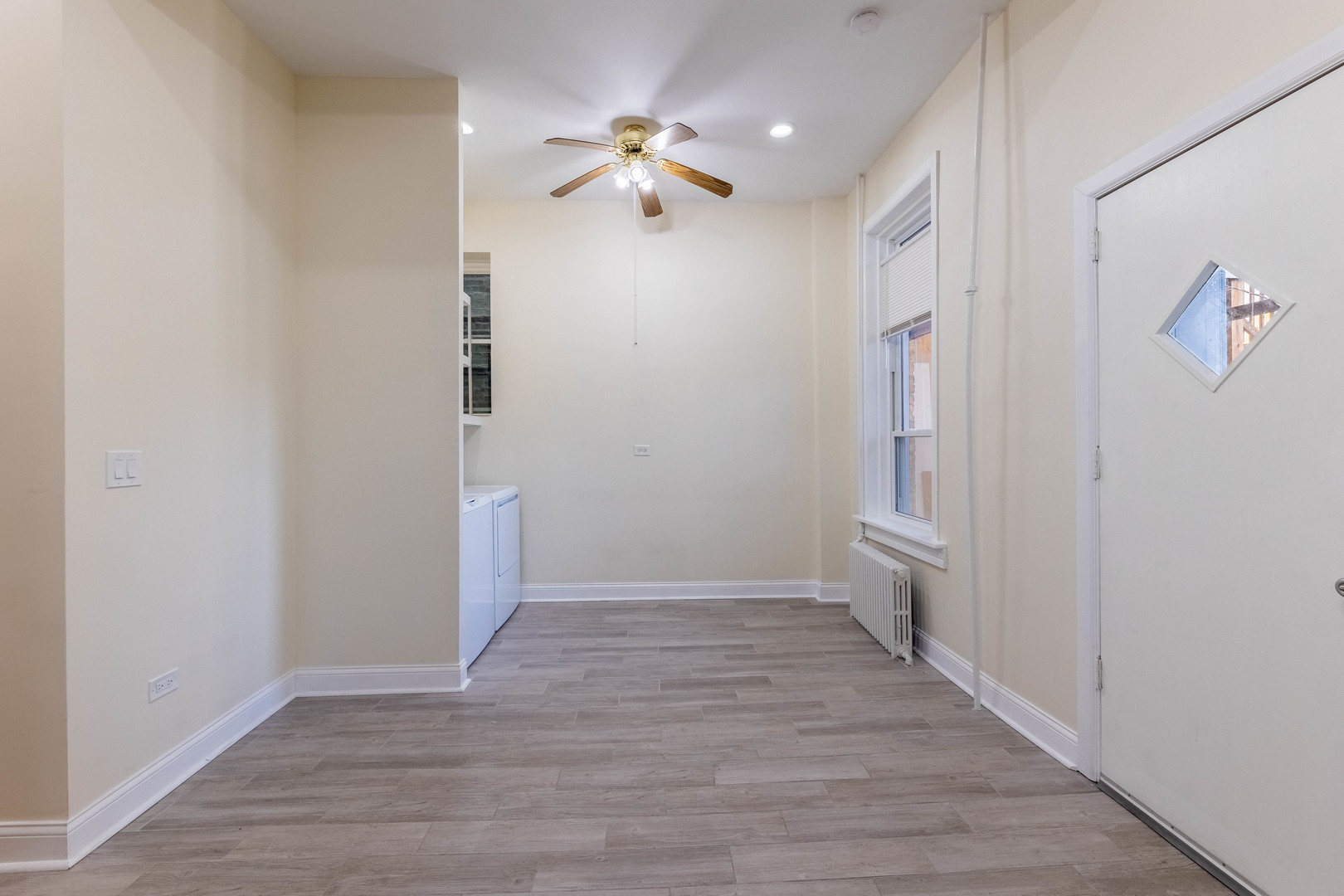 4549 South Wabash Avenue, Unit 1 Chicago, IL 60653 - Photo 30 of 44 a view of a hallway with wooden floor and a chandelier fan