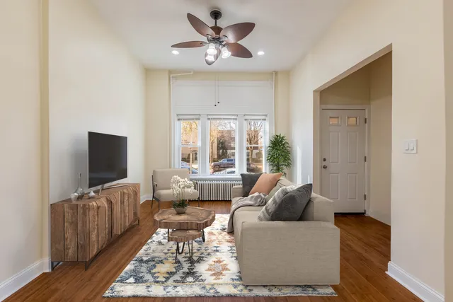 a living room with furniture ceiling fan and a rug