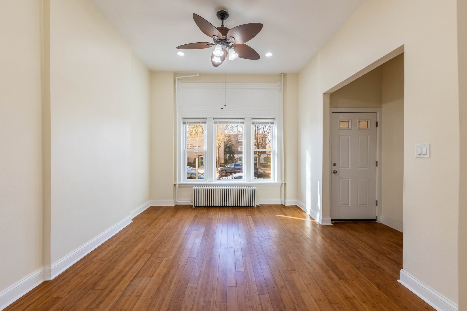 4549 South Wabash Avenue, Unit 1 Chicago, IL 60653 - Photo 4 of 44 an empty room with wooden floor and windows
