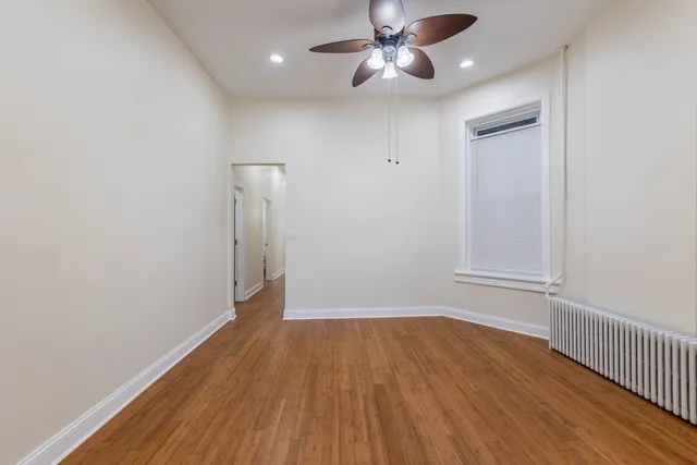 wooden floor in an empty room with a window