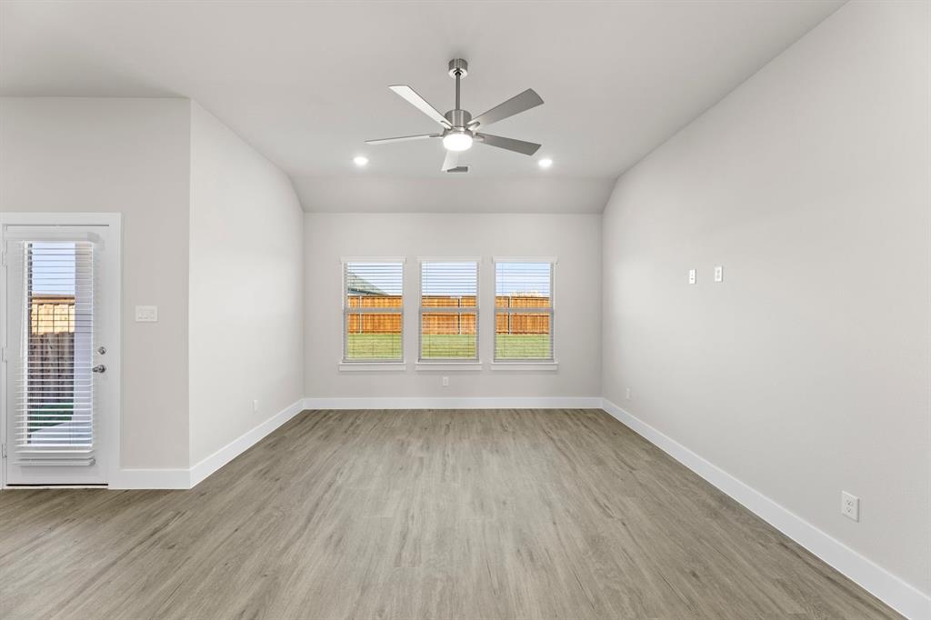 2372 Bell Way Forney, TX 75126 - Photo 9 of 39 wooden floor in an empty room with a window
