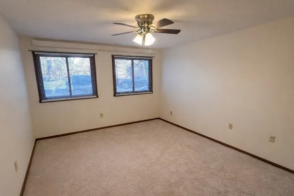 a bedroom with bed and window