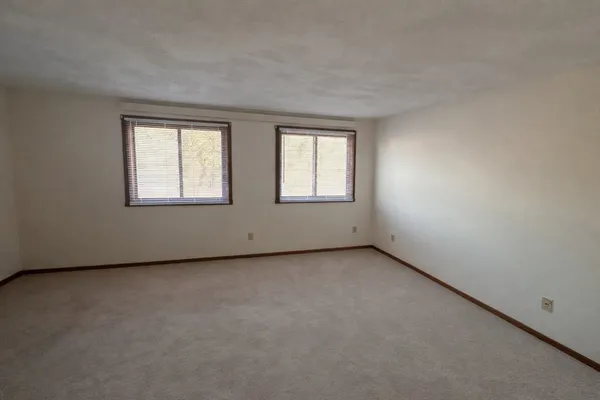 a large bed sitting in a bedroom next to a window